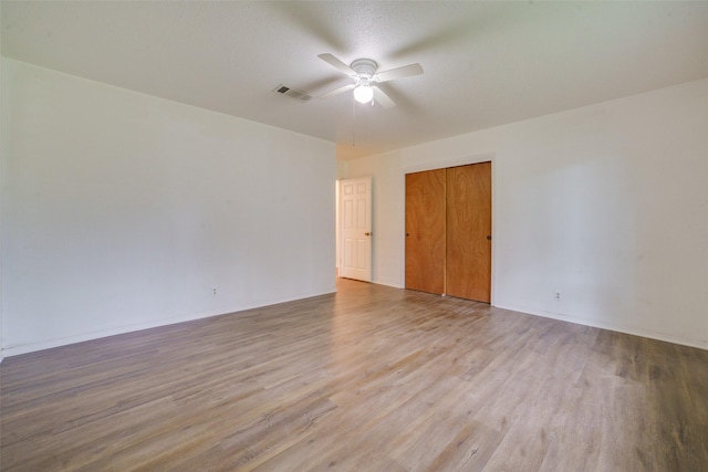 unfurnished room with ceiling fan and light wood-type flooring