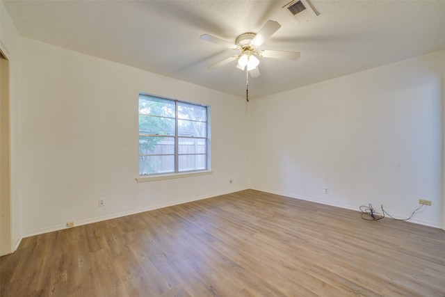 unfurnished room featuring ceiling fan, a textured ceiling, and light hardwood / wood-style flooring