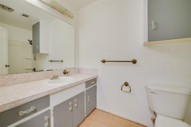 bathroom with tile patterned floors, vanity, and toilet