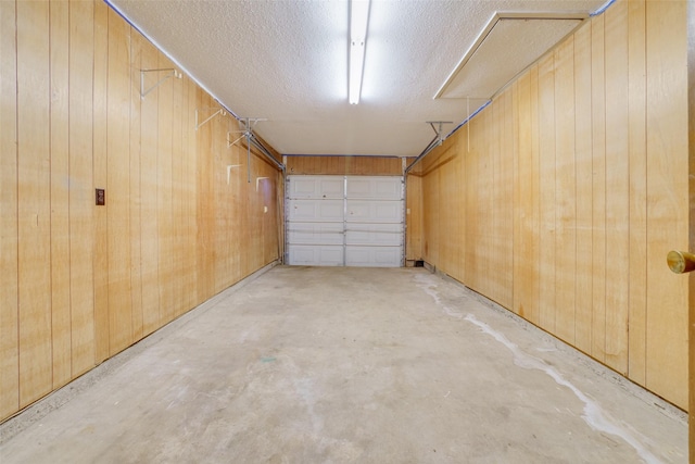 garage featuring wood walls