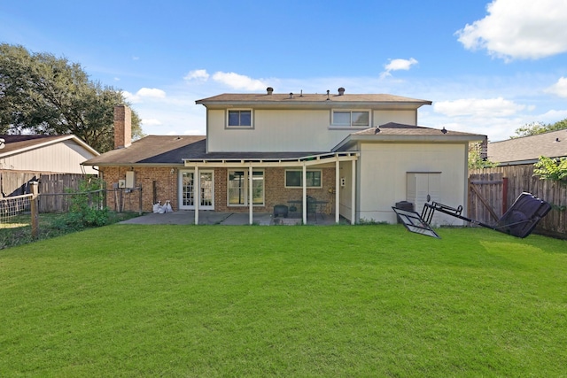 back of property featuring a patio and a lawn