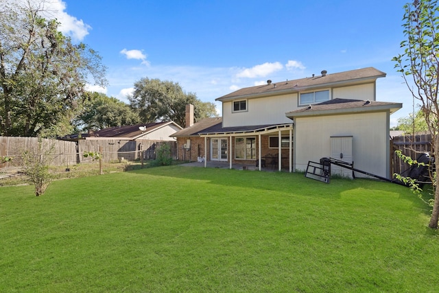 back of house with a lawn