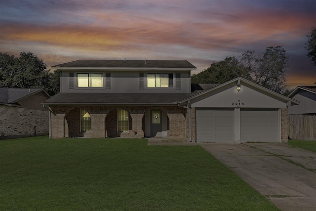 front of property with a lawn and a garage