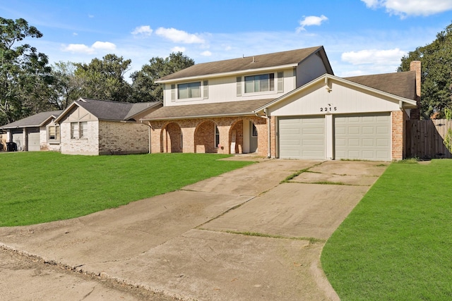 view of property with a garage and a front lawn