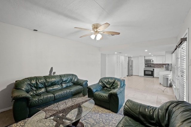 living room featuring a textured ceiling and ceiling fan