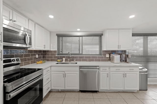 kitchen featuring plenty of natural light, sink, white cabinetry, and stainless steel appliances