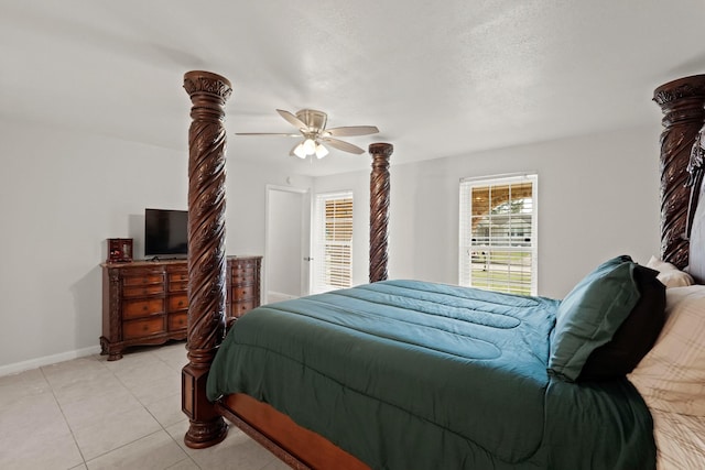 tiled bedroom with ceiling fan and a textured ceiling