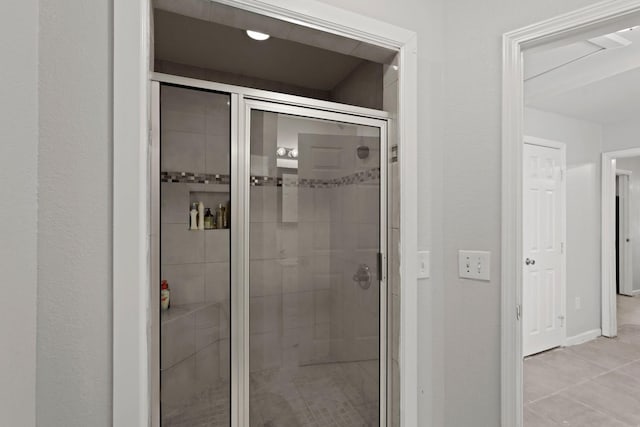 bathroom with tile patterned floors and an enclosed shower