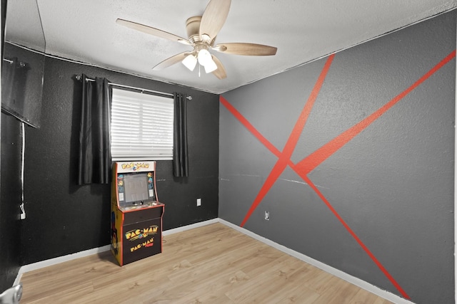 empty room featuring wood-type flooring and ceiling fan