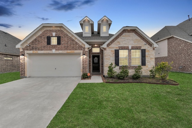 view of front facade featuring a garage and a lawn