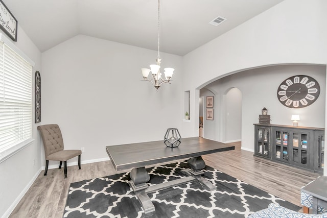 office area featuring hardwood / wood-style flooring, lofted ceiling, a wealth of natural light, and an inviting chandelier