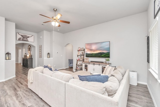 living room with ceiling fan and hardwood / wood-style floors