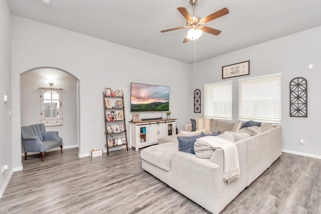 living room featuring ceiling fan and wood-type flooring