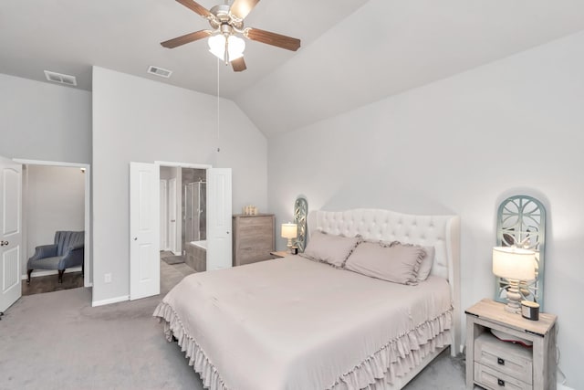 bedroom featuring ceiling fan, carpet, ensuite bathroom, and high vaulted ceiling