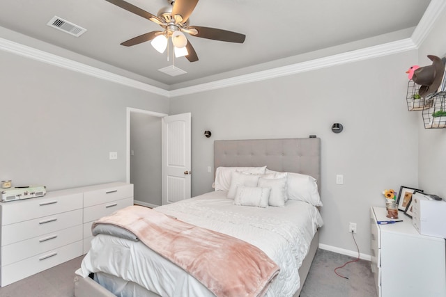 carpeted bedroom with ceiling fan and ornamental molding