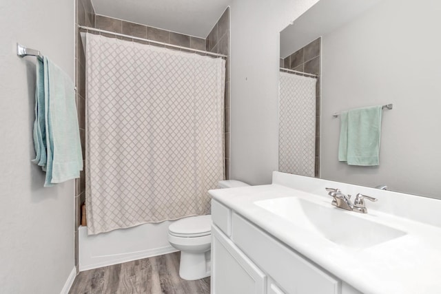 full bathroom featuring hardwood / wood-style floors, vanity, toilet, and shower / bath combo with shower curtain