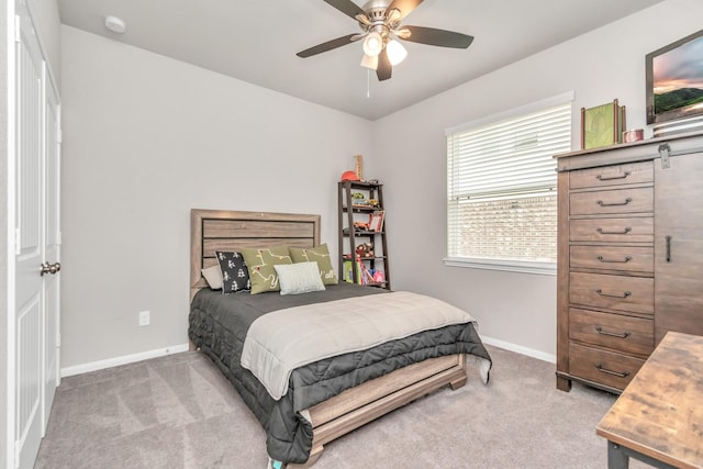 bedroom with ceiling fan and light colored carpet