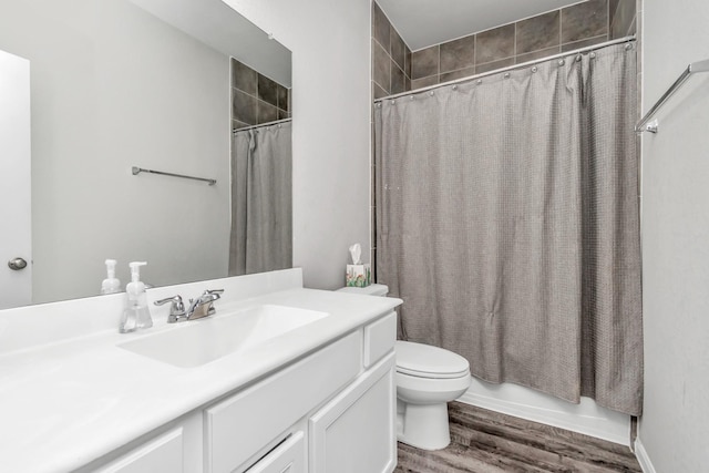 full bathroom with wood-type flooring, vanity, toilet, and shower / bath combo with shower curtain