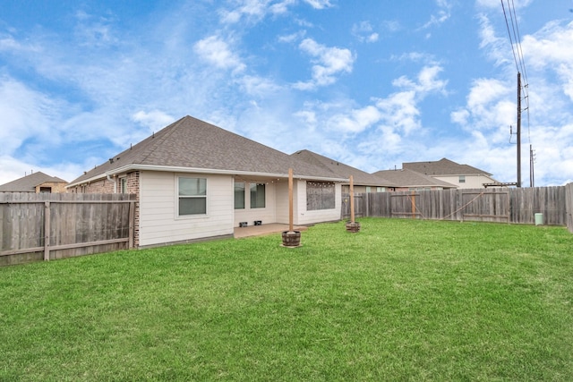 back of house with a lawn