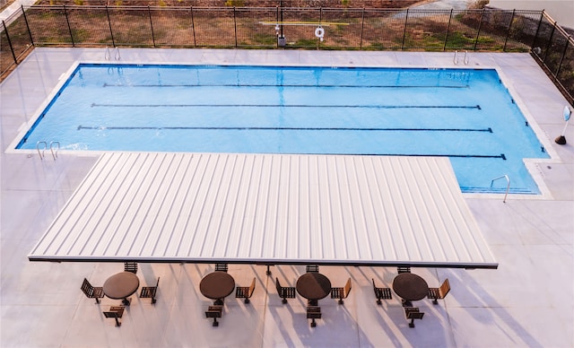 view of swimming pool featuring a patio area