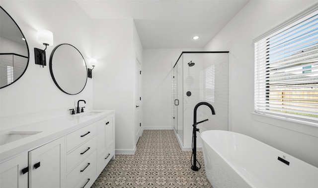 bathroom featuring tile patterned floors, vanity, and shower with separate bathtub