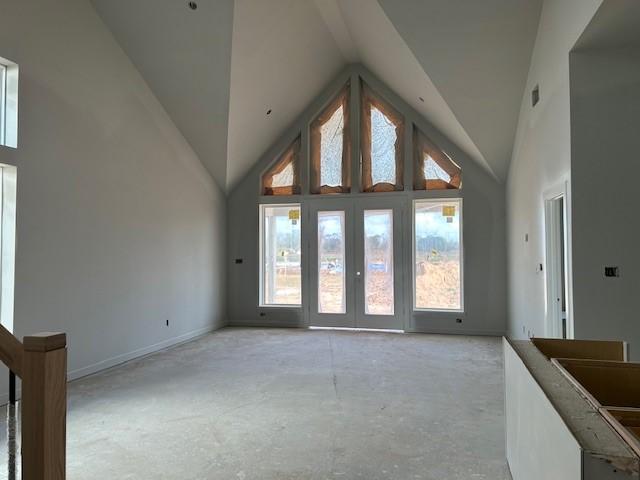 interior space with french doors, high vaulted ceiling, and plenty of natural light