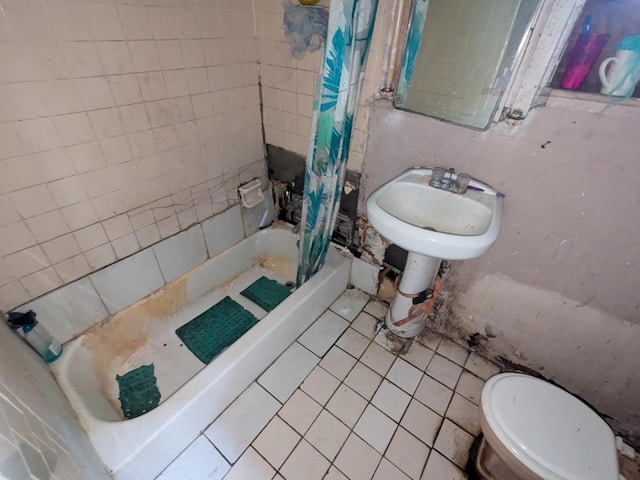 bathroom featuring tile patterned flooring, shower / tub combo, and toilet