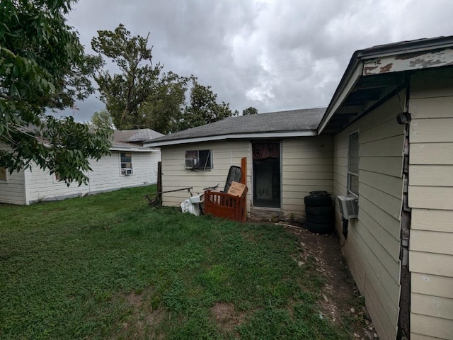 rear view of house with cooling unit and a lawn