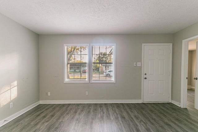 interior space with dark hardwood / wood-style flooring and a textured ceiling