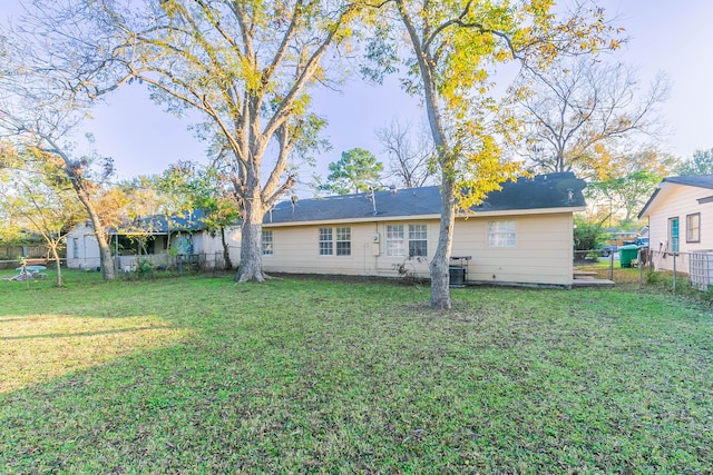 back of property featuring a lawn