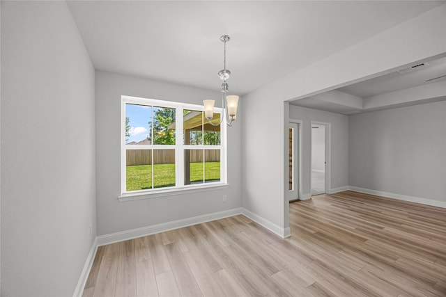 10318 Prairie Dunes Ln, Cleveland, TX 77327 - unfurnished room with a chandelier, light wood-style floors, and baseboards