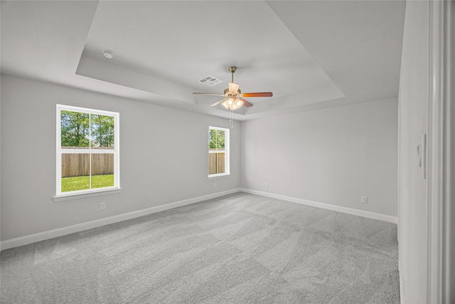 10318 Prairie Dunes Ln, Cleveland, TX 77327 - empty room featuring a raised ceiling, plenty of natural light, and baseboards