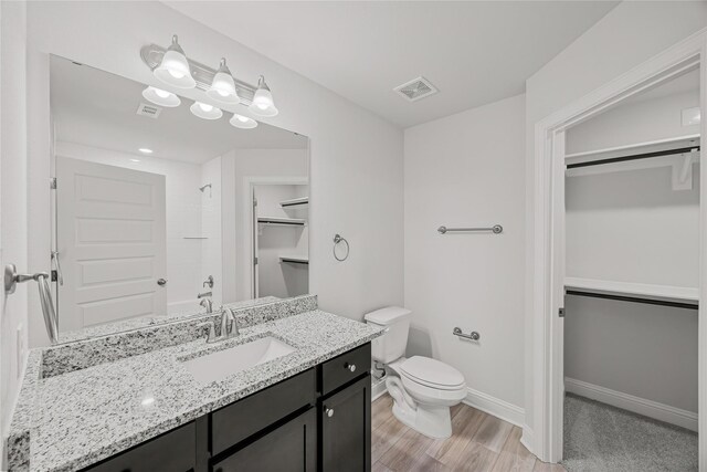 10318 Prairie Dunes Ln, Cleveland, TX 77327 - full bath with a shower, toilet, a walk in closet, vanity, and baseboards