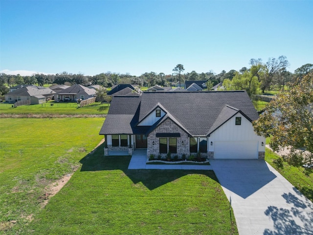 view of front of home with a front yard and a garage