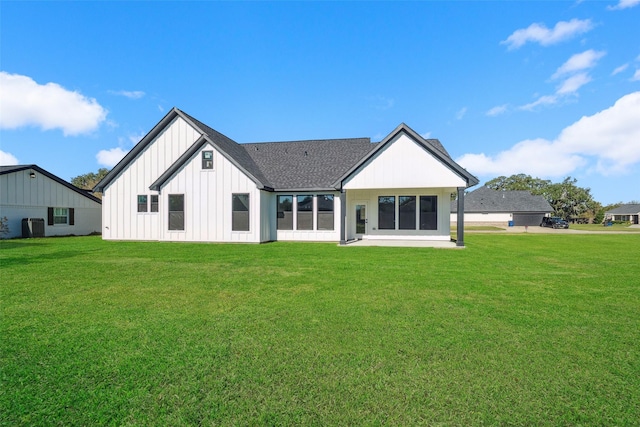 rear view of property featuring a yard