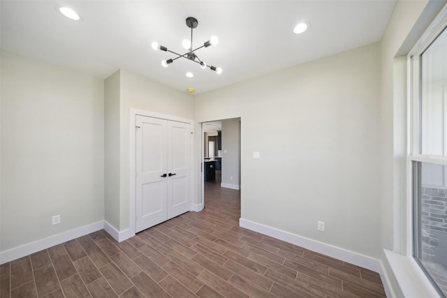 interior space featuring dark wood-type flooring and a notable chandelier