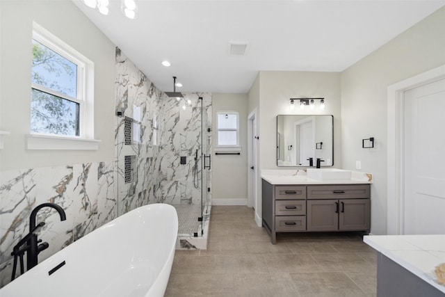 bathroom with tile patterned floors, vanity, a healthy amount of sunlight, and shower with separate bathtub