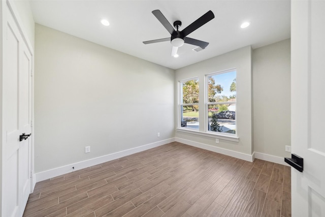 spare room with ceiling fan and light hardwood / wood-style flooring