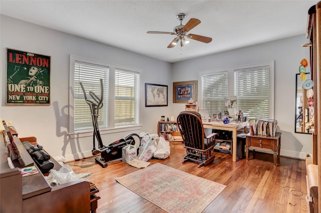 home office featuring light wood-type flooring and ceiling fan