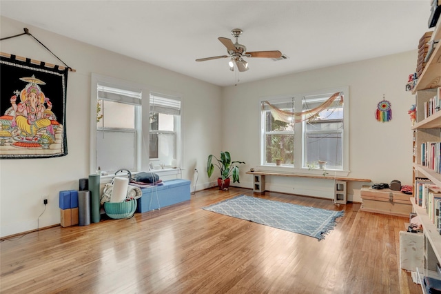 misc room with light hardwood / wood-style flooring and ceiling fan