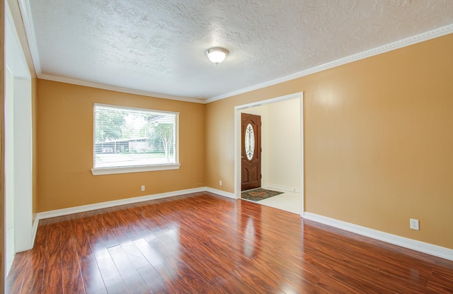 entrance foyer featuring hardwood / wood-style floors, a textured ceiling, and crown molding