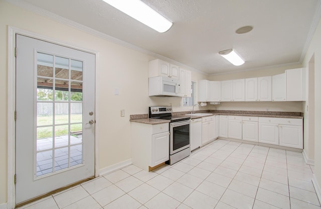 kitchen featuring white appliances, white cabinets, sink, ornamental molding, and light tile patterned floors