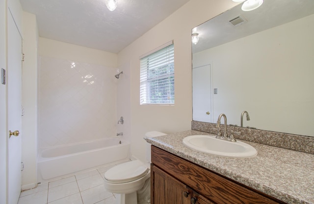 full bathroom featuring tile patterned flooring, tiled shower / bath combo, toilet, and vanity