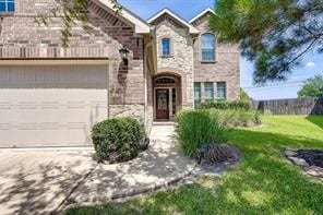 view of front of home featuring a garage and a front yard