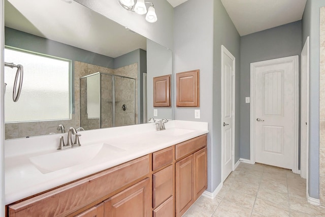 bathroom with vanity and a shower with shower door