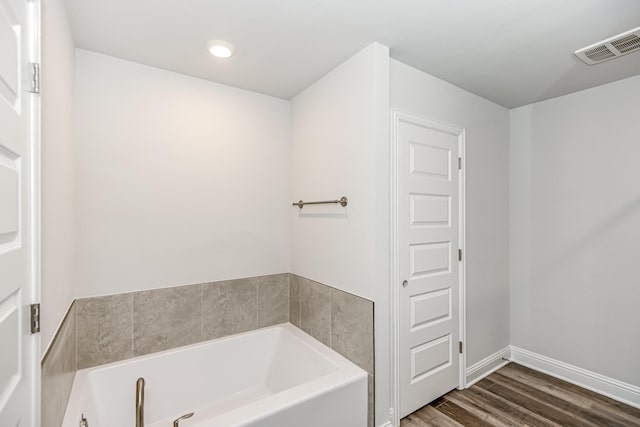 bathroom featuring hardwood / wood-style flooring and a bathtub