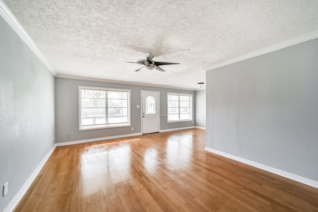 interior space with plenty of natural light, light hardwood / wood-style floors, and a textured ceiling