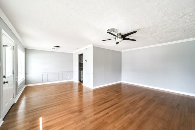 spare room featuring hardwood / wood-style flooring, ceiling fan, ornamental molding, and a textured ceiling