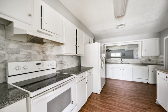 kitchen featuring sink, dark wood-type flooring, a textured ceiling, white appliances, and white cabinets