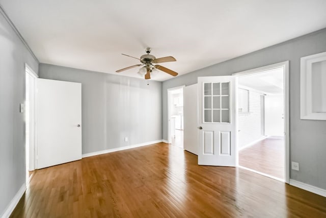 unfurnished room with ceiling fan and wood-type flooring